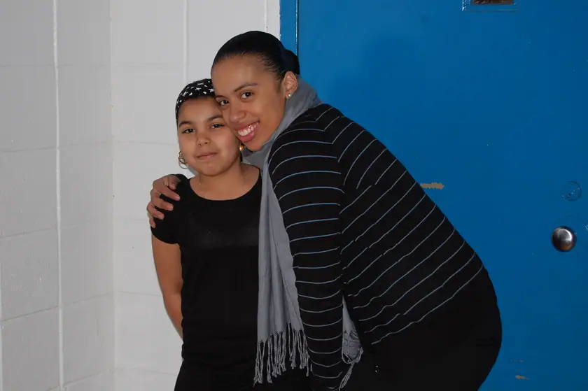 A mentor with her arm around her mentee
