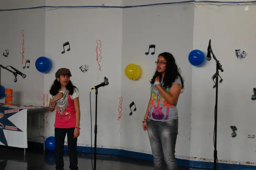 Two mentees singing at the talent show
