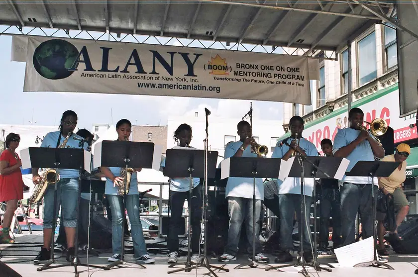 The youth band plays under the ALANY banner