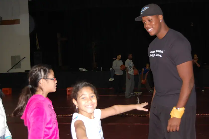 A coach with two mentees courtside