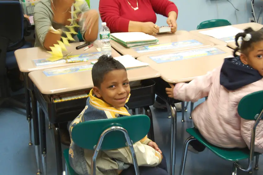 A mentee turns round from his desk