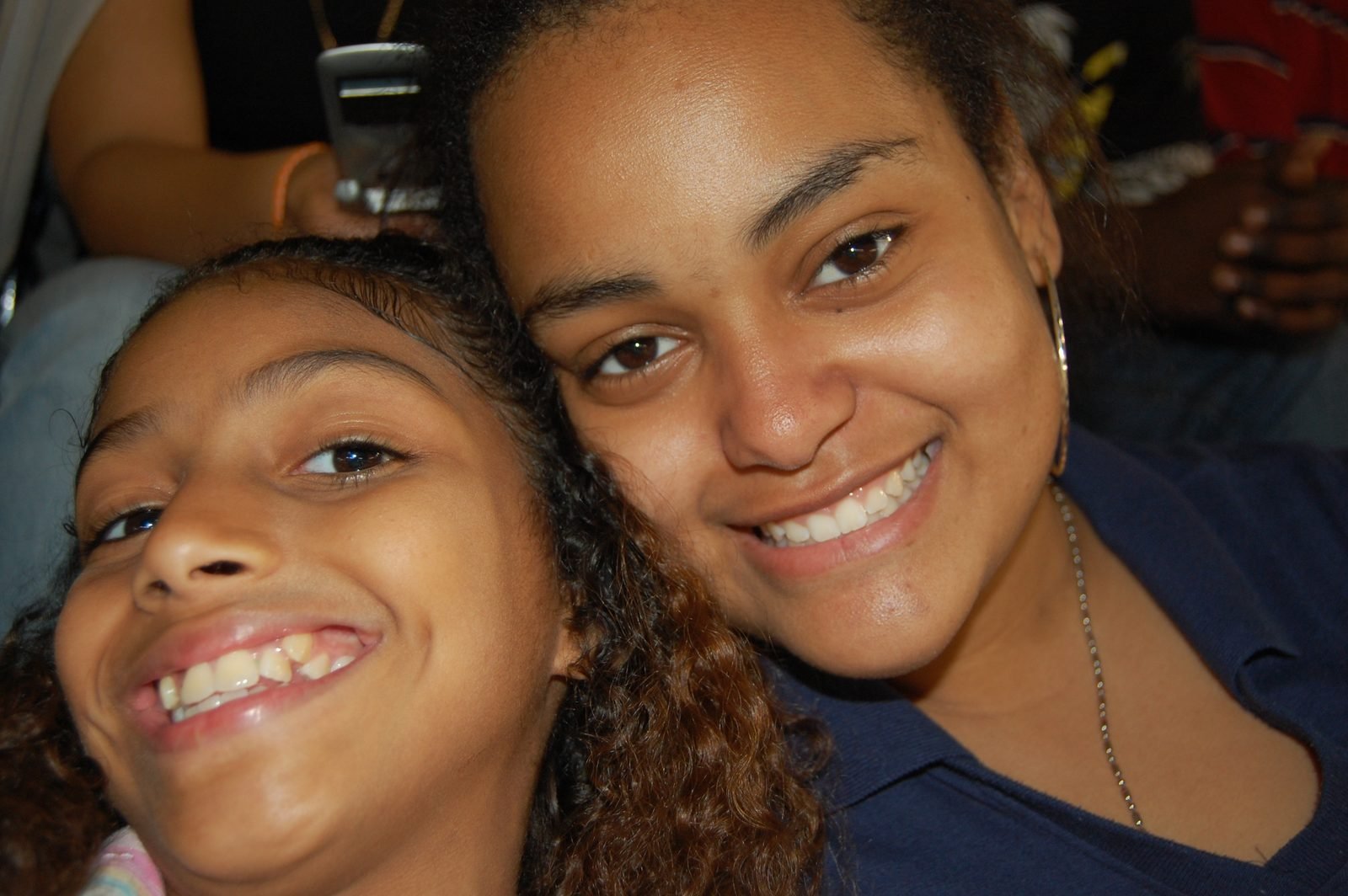 A BOOM mentee and her mentor lean in together, both smiling.