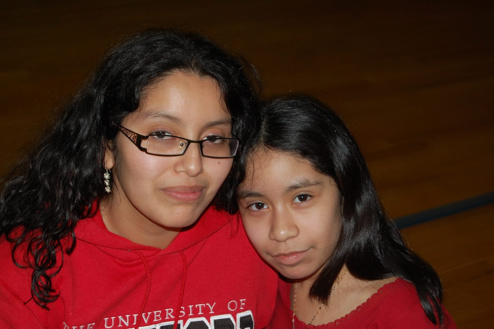 Two teenage mentees stand close together at a BOOM event.