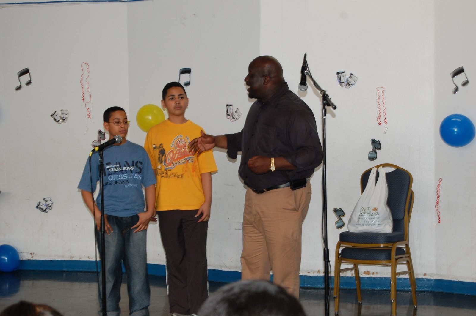 Mentees on stage with a programme host at the BOOM talent show.