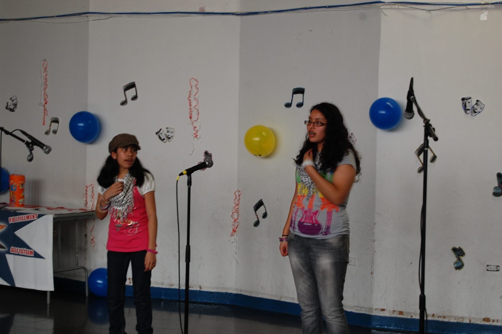 A BOOM mentee sings into a microphone at the programme talent show.