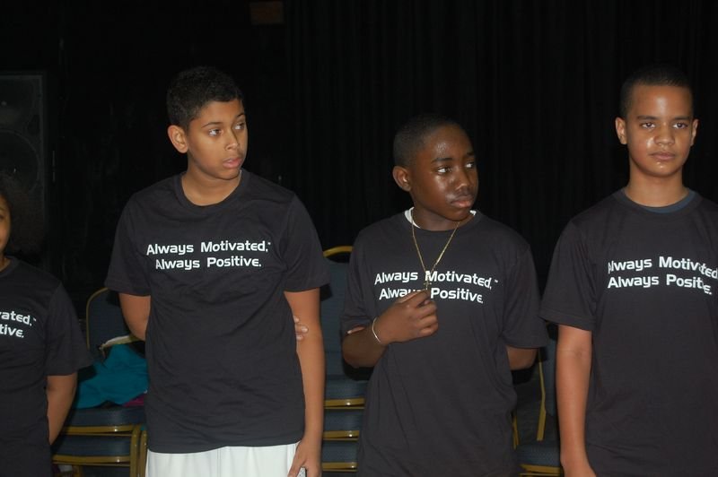 Three BOOM mentees in programme t-shirts reading Always Motivated, Always Positive.